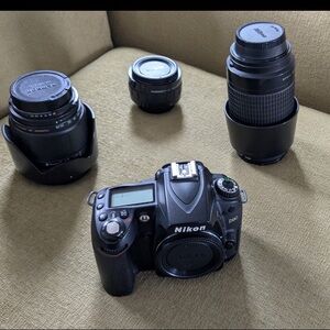 Nikon D90 digital camera with 3 lenses.